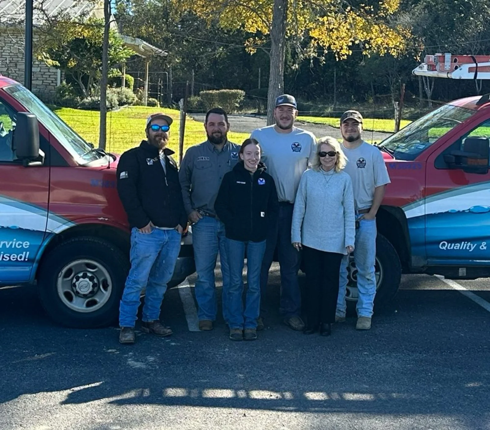 The Pulliam Plumbing team with their lettered service trucks outside the Boerne shop
